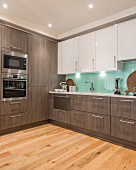 Elegant fitted kitchen with glass splashback