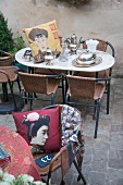 Antique silverware and Oriental cushion on marble table