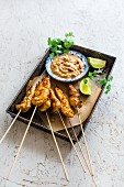 Chicken satay skewers with coriander and a peanut dip