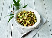 Tagliatelle with wild garlic pesto, dried tomatoes, capers and pine nuts