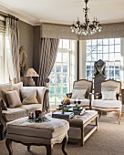 Period furniture and chandelier in elegant living room in shades of grey