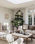 Period furniture and Christmas trees in elegant living room in shades of grey