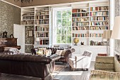 Pair of leather sofas in library with open shelving