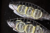 Trouts with lemon on grill racks