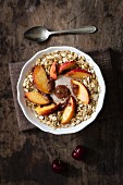 Cherry smoothie bowl with peach and oat flakes, topping