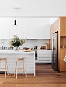 Wood and lots of white in a modern island kitchen