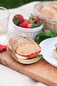 A caprese sandwich with ciabatta, mozzarella, tomato and basil