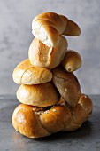 A stack of bread rolls and pastries made of white flour