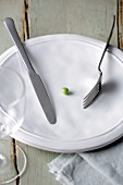 Fasting - one pea on a plate