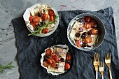 Feta with olives, tomatoes and herbs baked in the oven
