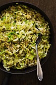 Fried spring cabbage in a cast iron pan