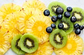 Blueberries and slices of kiwi and pineapple