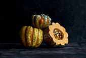 Three heirloom pumpkins, whole and halved
