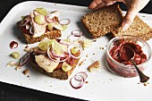 Wholemeal bread topped with smoked trout, grapes and beetroot spread