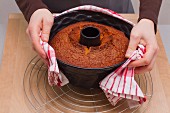 Removing a cake from a tin - wrap the tin in a damp tea towel and turn the cake out onto a cooling rack