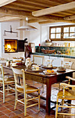 Wooden table and chair in kitchen with wood-fired oven