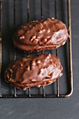 Chocolate-covered nut biscuits on a wire cooling rack