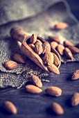 An arrangement of almonds on a wooden scoop