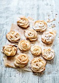 Rose-shaped pastries with cinnamon and icing sugar