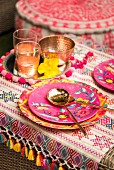 Table brightly set with ethnic patterns and copper