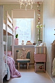 Bunk-beds in narrow children's bedroom in pastel shades