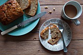 Banana cake on a plate and a cup of tea