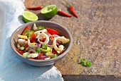 A squid salad with tomatoes, chilli, leeks and coriander