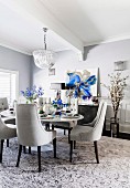 Glamorous dining room in shades of gray with blue accents