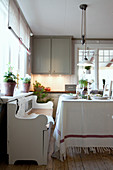 Traditional chest bench at dining table in country-house-style kitchen-dining room