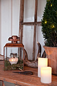 Rustic Christmas arrangement of candles, lantern and antlers