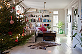 Christmas tree in living room with white wooden floor