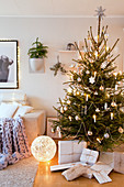 Decorated Christmas tree and gifts wrapped in white paper