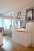 Gallery of pictures above sideboard in open-plan Scandinavian-style interior