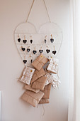 Wrapped gifts hung from wire heart as Advent calendar