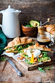 Croissants with shrimp, avocado, rocket and poached egg