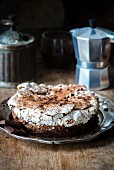 A flourless chocolate cake topped with a nut meringue