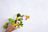 A paper bag with fresh fruit and vegetables