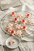 Star biscuits glazed with icing and topped with glace cherries