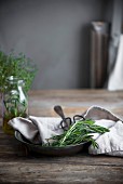 Rosemary on a linen cloth and a vintage metal plate