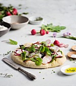 Focaccia bread with fresh salad and raw vegetable on marble table