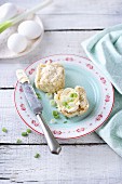 Hot cross buns (Easter buns, England) with clotted cream and spring onions