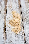 Popped amaranth and quinoa on a wooden background