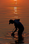 Man fishing at sunset, Brazil