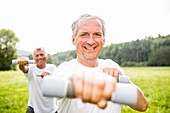 Two men exercising with hand weights