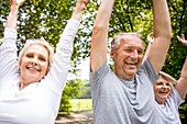 Three people with arms raised, candid portrait