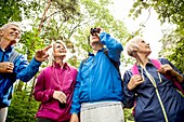 Four people on hike with binoculars