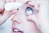 Person applying eye drops
