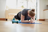 Young woman in plank position