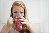 Young woman drinking homemade smoothie