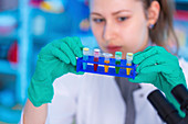 Scientist holding test tube rack